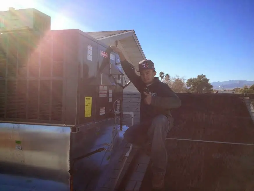 HVAC technician performing AC Tune-Up on a rooftop unit in Lincolnia